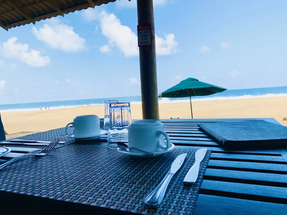 A beachfront table set for breakfast at Olin's Beach Restaurant