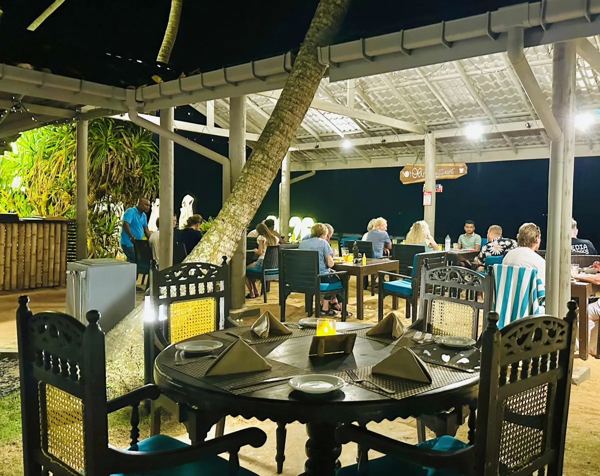 Guests dining at Olin's Beach Restaurant in the evening
